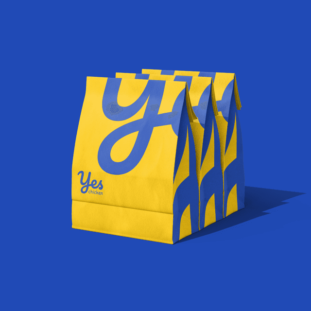 Stacked premium takeaway boxes featuring inverted brand colorways.
