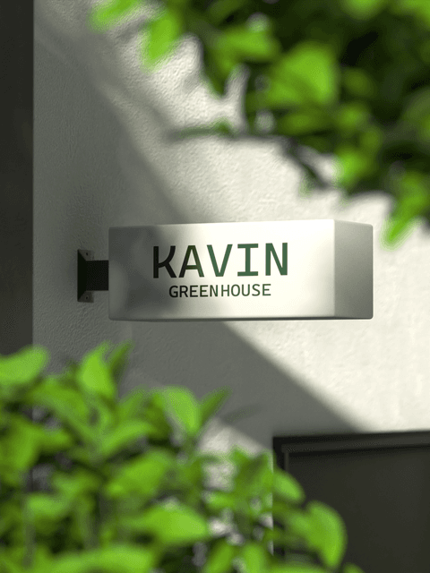 3D brand mark installation on a manicured grass lawn.